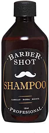 Una botella café transparente, con el tapón negro; en la etiqueta se lee: 'Barber shot' 'shampoo' 'profesional'. 